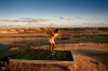 Teeing off at the driest golf course in the world in Coober Pedy.
