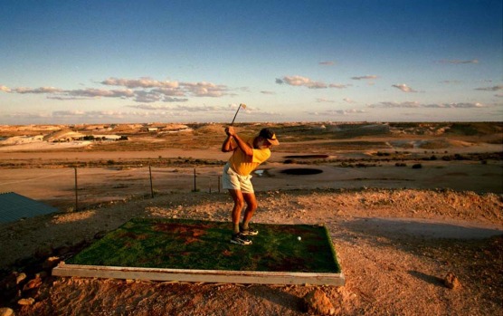 Teeing off at the driest golf course in the world in Coober Pedy.