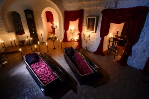 In this picture taken Oct. 9, 2016, two coffins are lit before a photo shoot in Bran Castle, in Bran, Romania. Airbnb ...