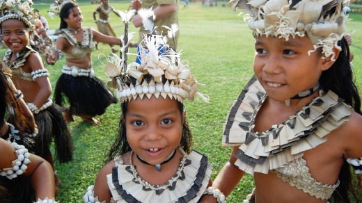 Local children participate in a Historical Village Dance, Fiji.