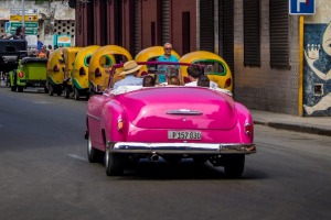 A vintage car passes Floridita restaurant in Old Havana.