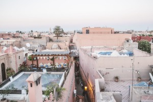 Pink-hued buildings stand among narrow alleyways in Marrakech.