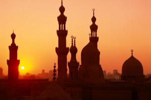 Domes and minarets dot the skyline at sunset in Cairo.