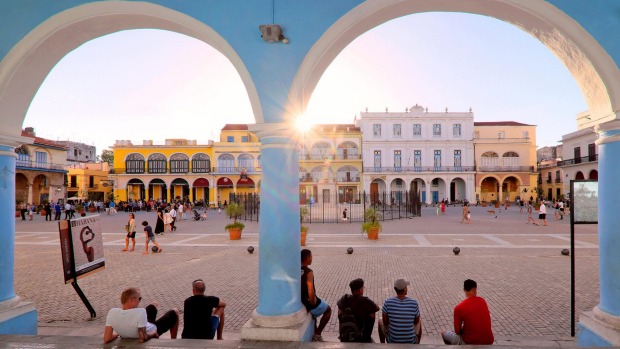 Sun setting over the colourful colonial buildings on Plaza Vieja / Old Square, Havana.