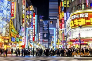 Brightly lit neon signs illuminate the popular nightlife Shinjuku district in Tokyo.