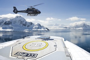 One of two on-board Airbus helicopter lands on the flight deck of Scenic Eclipse in Antarctica.