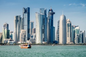 Traditional Dhow cruising in Doha Bay towards the modern Doha Skyscraper Skyline. Doha, Qatar, Middle East iStock image ...