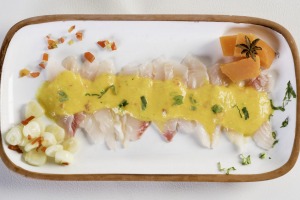 Tiradito is raw fish cut thin and long like sashimi and covered in a rich sauce.