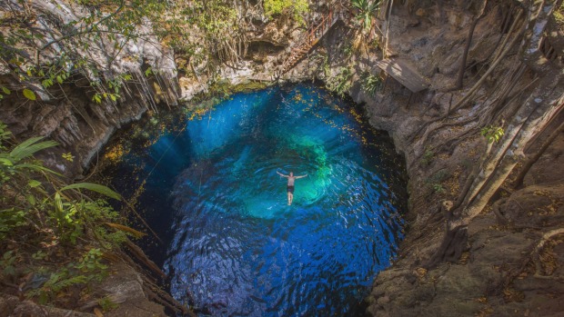 Swimming in a cenote in Mexico with G Adventures.