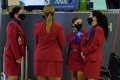 Virgin Australia staff wearing masks at Sydney Airport in December. Virgin crew are still required to wear masks on ...